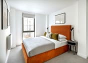 Thumbnail 8 of 12 - a bedroom with a bed and a window
