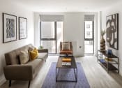 Thumbnail 1 of 12 - a living room with a couch and a coffee table