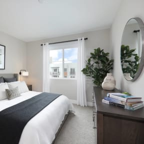 a bedroom with a bed and a dresser and a window