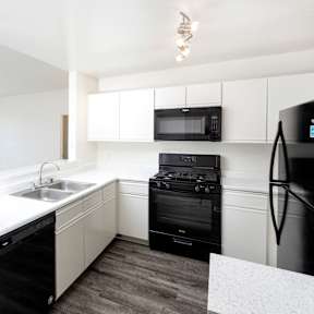 Kitchen with Stove top oven at White Oak Gardens, Encino, CA