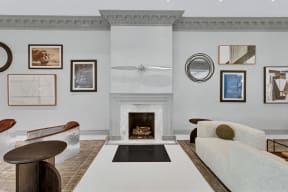 a living room with a couch and chairs and a fireplace