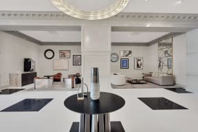 a living room with a black table and a white floor