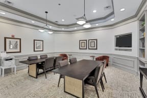 a conference room with a large table and chairs and a television