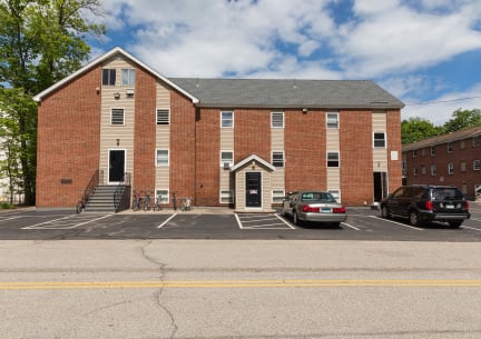a large brick building with a parking lot in front of it