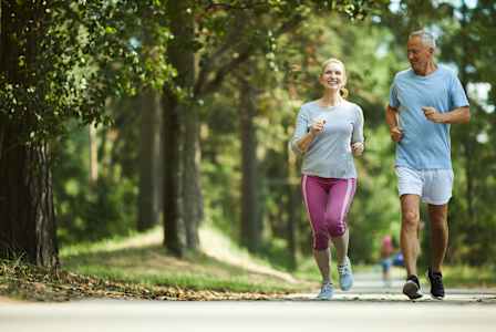 Two people jogging in a park.