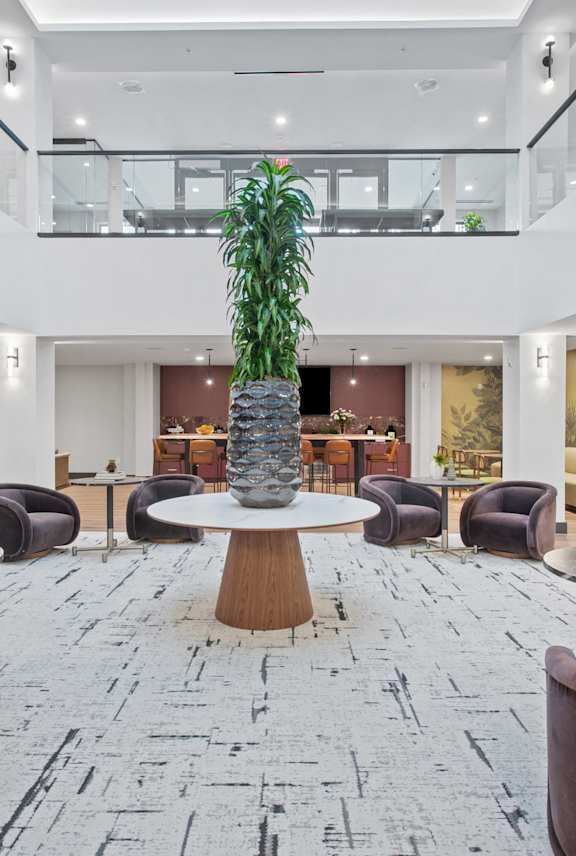 a living room with a couch and chairs and a balcony