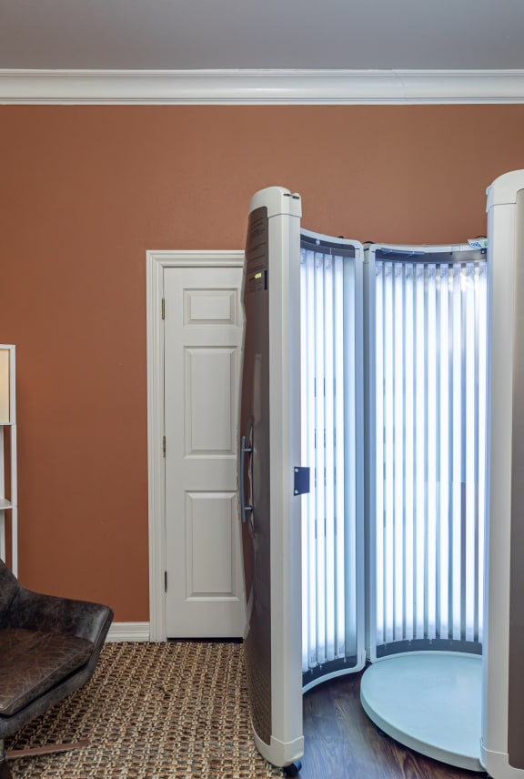 a room with a heater and a chair and a window