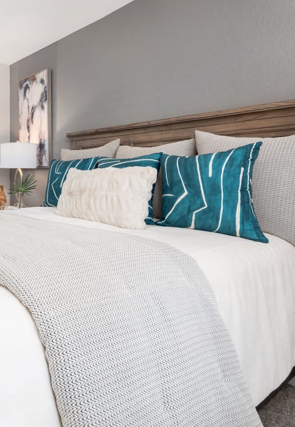a bedroom with a large bed and a door to a bathroom