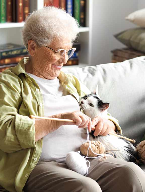 An elderly woman is knitting at Union at Tower District, Kansas, 66612