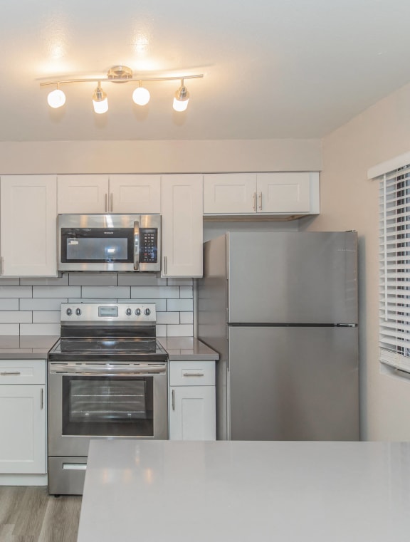 a kitchen with stainless steel appliances and a sink