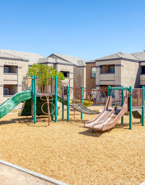 a playground with slides in an apartment complex