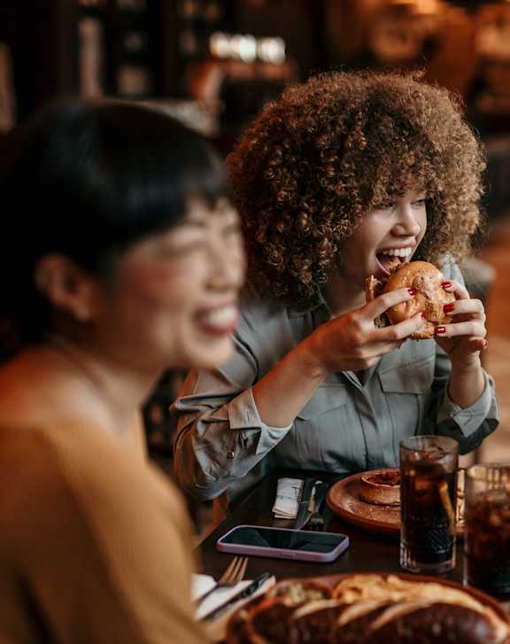 Three people eating pizza at a table.at The Arvon, Vancouver, 98662