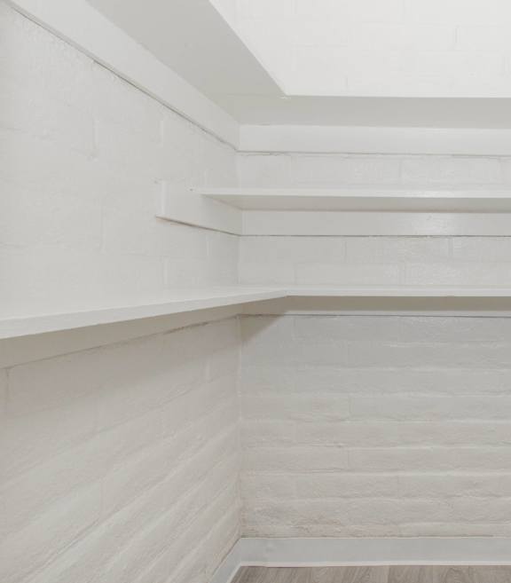 A white staircase with a skylight above it.