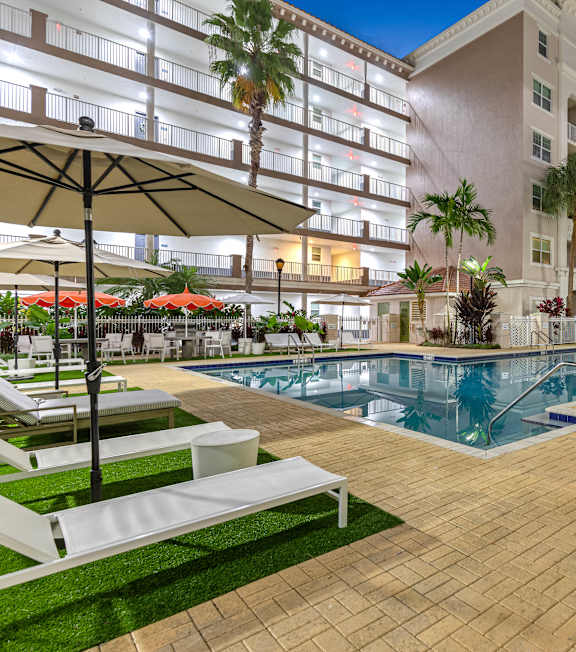 A pool with a green wall behind it.