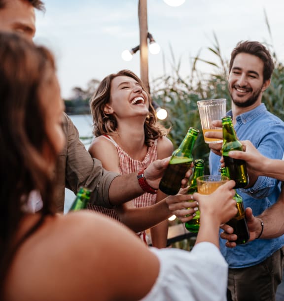a group of people celebrating with drinks at a party