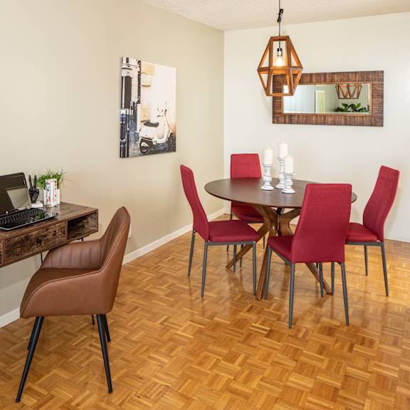 A brown chair is in front of a desk with a laptop on it.