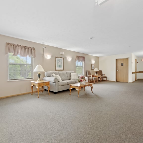 a large living room with a couch and tables