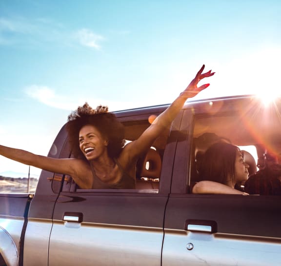 group of young people riding in the back of a car