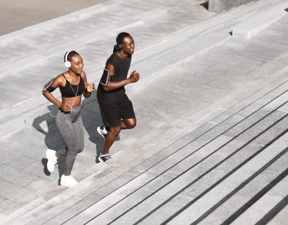 two adults working out and running up stairs at Topaz Apartments, Los Angeles, CA, 90013