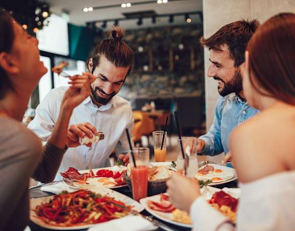 A group of people enjoying a meal together at a restaurant.
