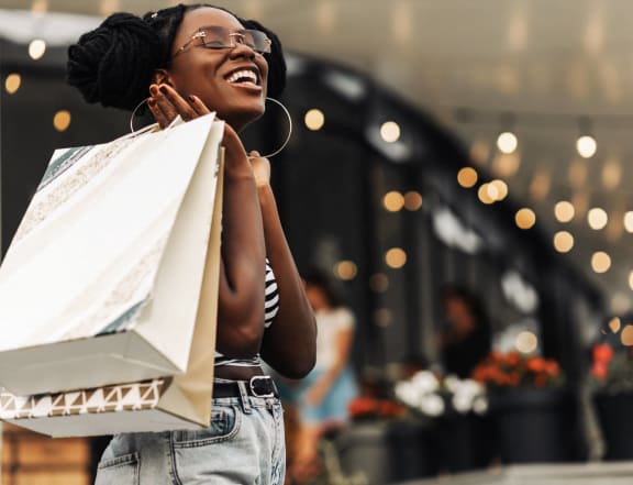 a woman holding shopping bags in a store