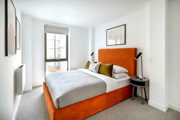 a bedroom with a bed and a window