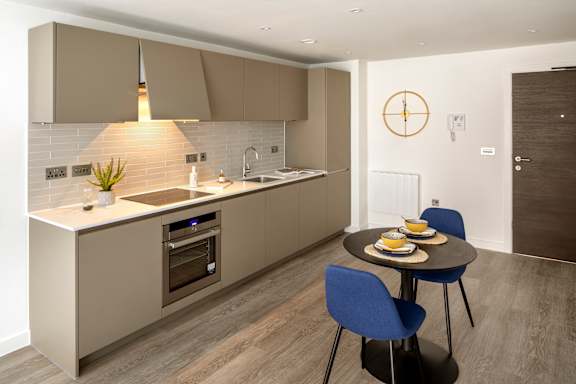 a kitchen with a table and chairs and a sink