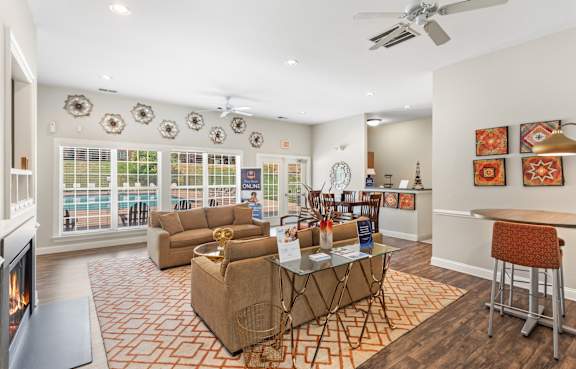 A living room with a fireplace and a glass table.
