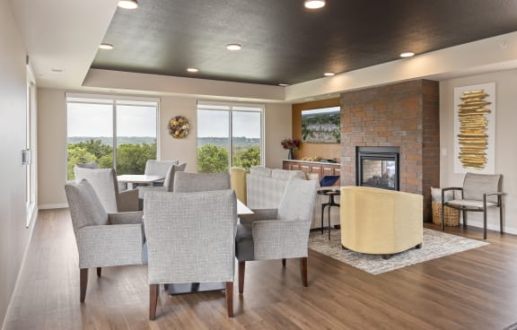 a living room with a fireplace and a large window