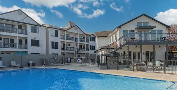 a large swimming pool in front of an apartment building
