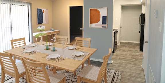A dining room with a table set for two.