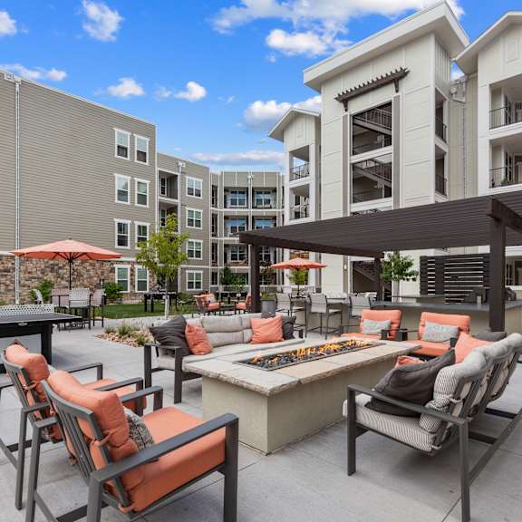 The Zeb Apartments in Colorado Springs, CO Patio with Lounge Seating, a Ping Pong Table, and a Fire Pit