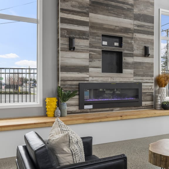 a living room with a fireplace and a large window