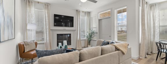 a living room with a couch and a ceiling fan