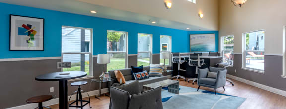 a living room with couches chairs and tables and a piano