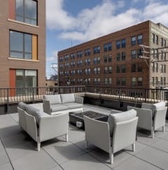 A seating area on the roof of a building with a fire pit at Mercantile on Broadway, Fargo, North Dakota 58102