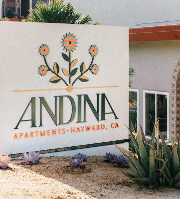 White monument sign reads Andina in front of apartment building