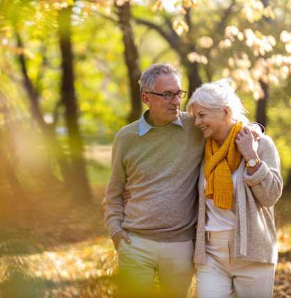 a man and a woman walking in the park