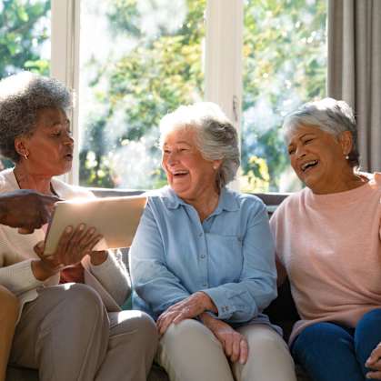 Four people sitting on a couch, sharing a moment together.