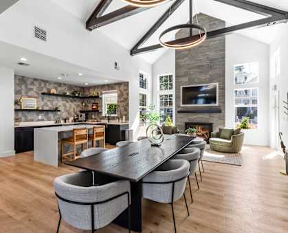 A modern dining room with a large table and chairs.