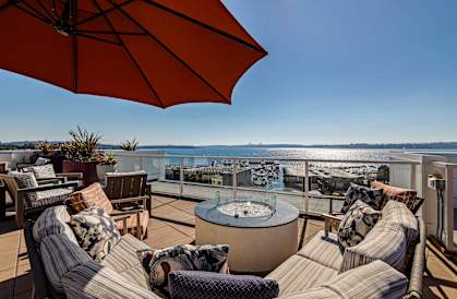 a seating area with a fire pit and a view of the water