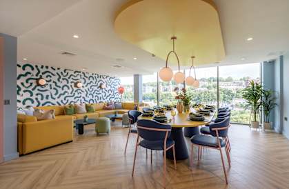 a dining room with a table and chairs