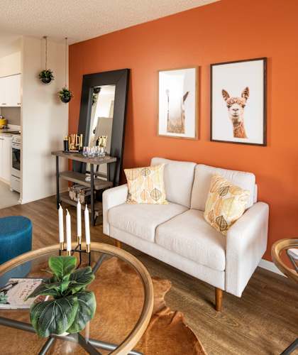 A living room with a white couch and a coffee table.
