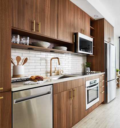 a kitchen with wooden cabinets and a sink and a window