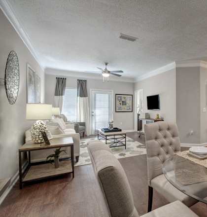 a living room and dining room with a table and chairs