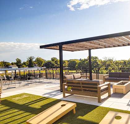 a rooftop patio with lounge furniture and a pergola at Riverhouse Apartments, Fargo, North Dakota 58102