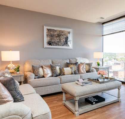 a living room with a large window and a view of the city