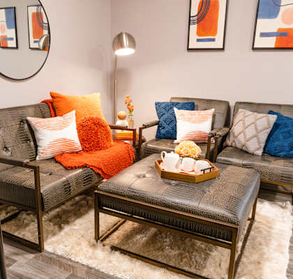 a living room with couches and pillows and a table