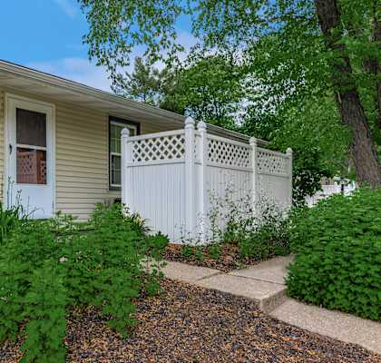 a white fence in front of a house