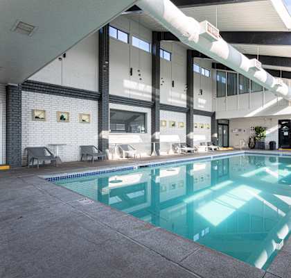 A large indoor swimming pool with a skylight above it.